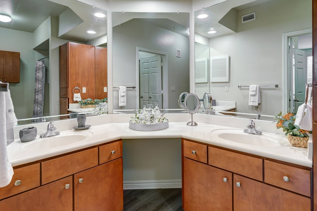 A bathroom with a large mirror and two sinks.